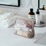 taupe: beauty essentials holding toiletries