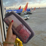 shadow: beauty everyday at the airport holding toiletries