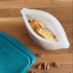 snow dots: 2-cup reusable silicone bowl with biscotti inside