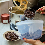 all: 4-cup stasher bowl being used to add chocolate to cookies