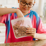 ALL: sandwich clear storing pretzels, kid holding and eating from the Stasher bag. 