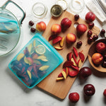yellow sea: half gallon in aqua holding slices of nectarines. 