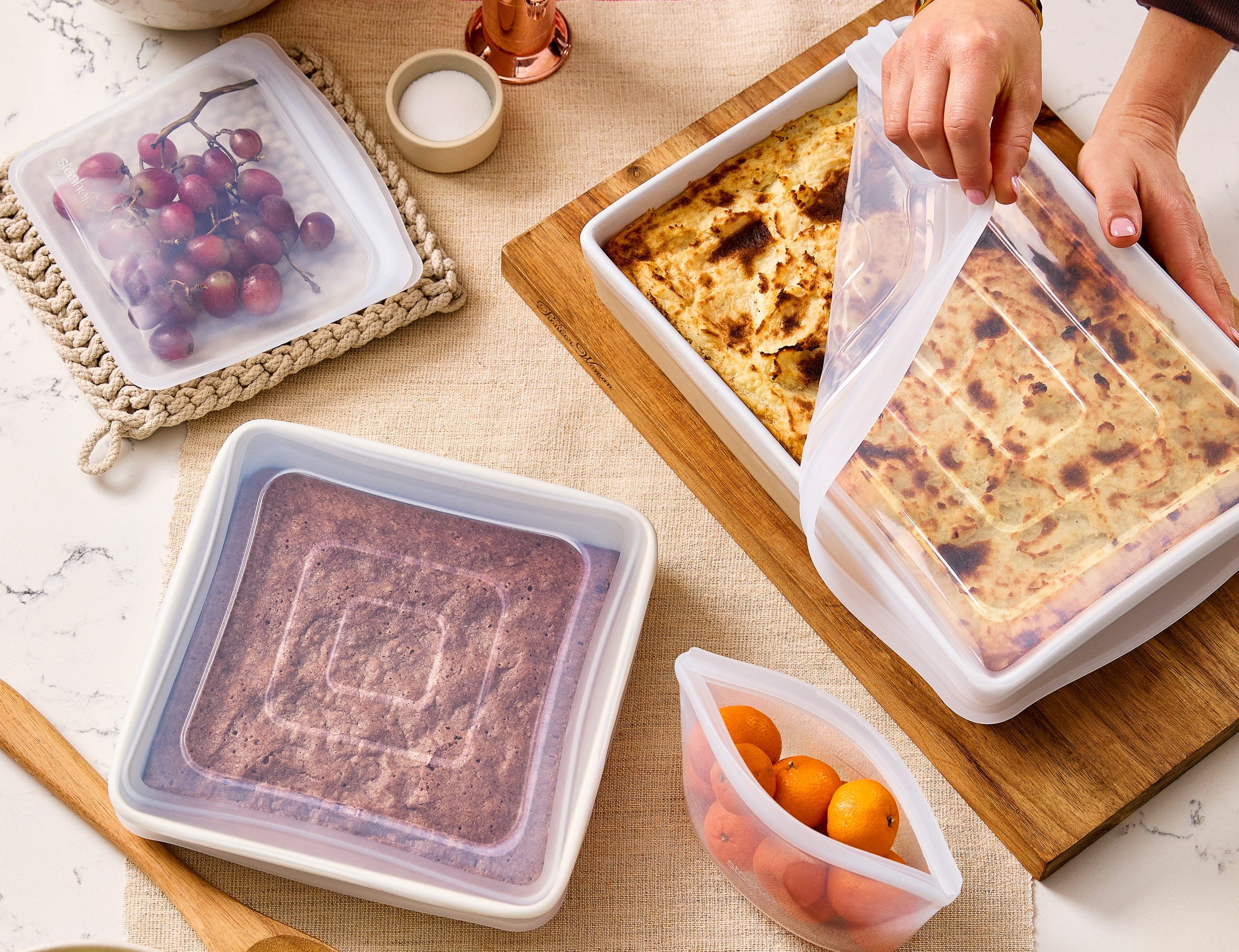 Square stretch lids covering an 8x8 pan of brownies. And a rectangular 9x13 stretch lids covering a baked casserole dish. 