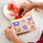 bee: bee paper snacj bag holding heart cookies. 