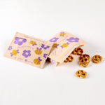bee: paper snack bags with bee prints holding pretzels. 