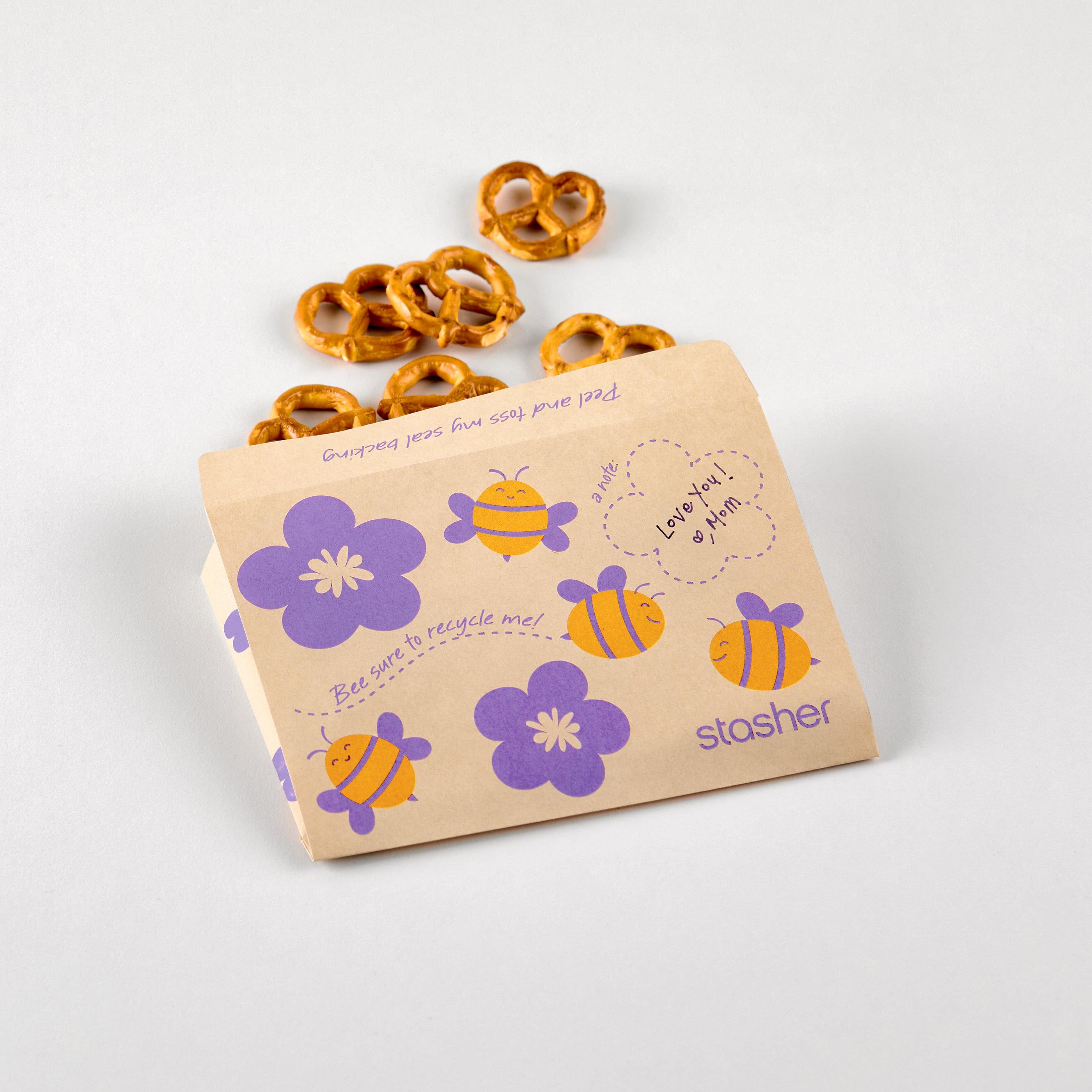 bee: paper snack bags with bee prints holding pretzels. 