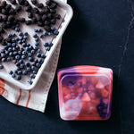 all: tie dye sandwich pink holding blueberries.