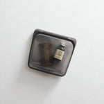 black: hero image of black stasher sandwich bag holding a beard comb