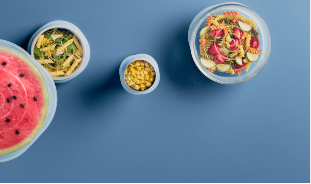 Stretch Lids Collection Page. Image showing multiple stretch lid sizes covering a variety of bowls with food. 