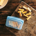 all: snack blue holding sliced cheese.