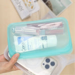 all: snack bag in aqua holding lipgloss and lotion. 