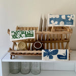 all: stasher reusable swedish dish cloths hanging on a sink drying rack