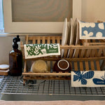 all: reusable swedish dish cloths hanging over a kitchen drying rack