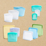 all: Set of silicone food storage containers in various colors on a brown background