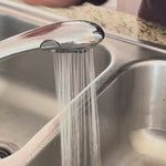 all: stasher small stretch lid being washed in the sink under water. 