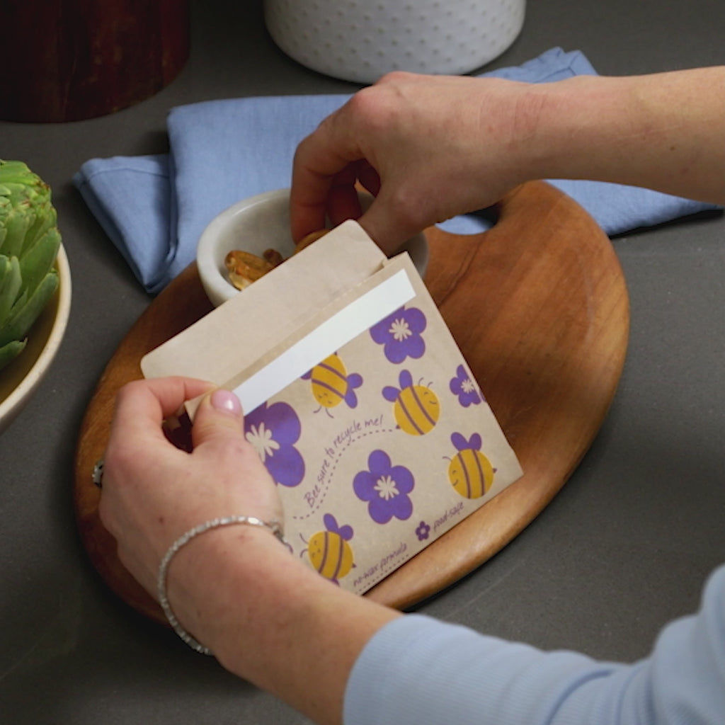 all: paper snack bag with bee print storing pretzels.