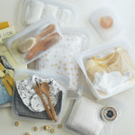 all: clear reusable bags holding baby items. 
