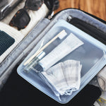 all: half gallon clear holding toiletries in suitcase. 